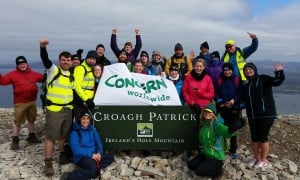 Group of climbers celebrate reaching top of Croagh Patrick