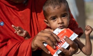 Rashida holds her severely malnourished son, Rasheed (15 months), while feeding him RUTF in Ahmed Jotorr village, Tharparkar. (Photo: Arif Shad/Ingenious Captures/Concern Worldwide)