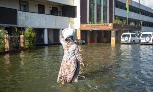 A woman outside the office of Deputy Commissioner in Noakhali district, Bangladesh with flood response materials. Photo: Akram Hossain/Concern Worldwide