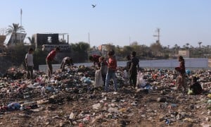 Children in Gaza search through a rubbish dump.