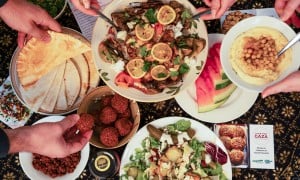  Dinner part scene shown from above. People share Palestinian food. 