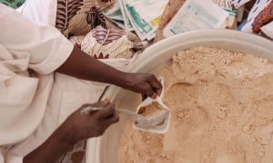 Production of MISOLA® Enriched Flour. Fifteen women from the Afani Yara Women's Group work on the production of Misola. Each 500gr bag sells at 500 cfa. Each child needs 100 gram/day of food supplement for 5 days for recovery. (Photo: Ollivier Girard/Concern Worldwide)