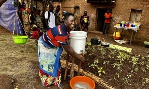 Maman Lumiere (lead mother) demonstrating hand washing in Karusi, Burundi. Photo: Diane Moyer/Concern Worldwide.