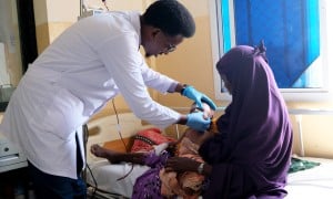 Doctor Muhammad Dek Jama treats Najma* (29) and her baby Cabdi* (18 months) at Banadir Hospital's Stabilisation Centre, Mogadishu. Photo: Hugh Golden/Concern Worldwide