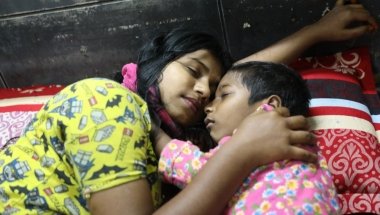 Sadia* (15) and her brother Mahir* sleep safely in a Concern supported Pavement Dweller Centre (PDC)