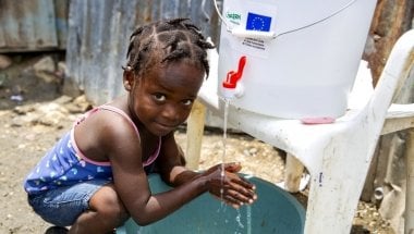 Cherica (2) washes her hands in front of her grandmother&#039;s home in Cite Soleil, a district of Port-au-Prince, Haiti. Photo: Dieu Nalio Chery/ Concern Worldwide
