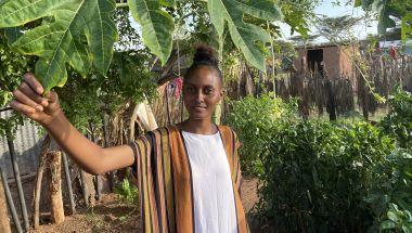 Young woman in a kitchen garden in Kenya