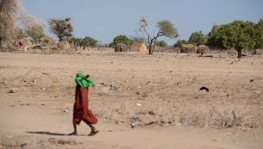 Child walking across desert land