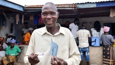 Victor S Canteh (46) holds his vaccination card after receiving his second vaccination in Madif. &#039;I am very glad I was able to get my second dose.’ Photo: Conor O&#039;Donovan / Concern Worldwide.