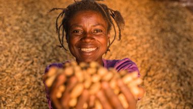 Congolese woman with the harvests from her peanut farm