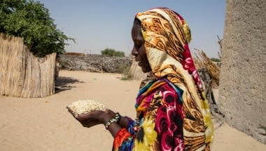 Sala Gana Ali (40) showcases some of the millet bran she feeds her goats at her home in Ndjati village, Baga Sola. (Photo: Eugene Ikua/Concern Worldwide)