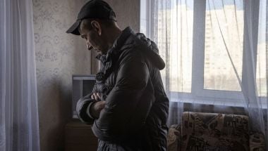 A man looks at the damage in his flat in north eastern Kharkiv due to conflict in the region. (Photo: Ed Ram/Concern Worldwide)