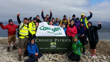 Group of climbers celebrate reaching top of Croagh Patrick