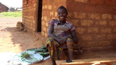 Tiyassi Joanette sits outside her home in Central African Republic on a sunny day