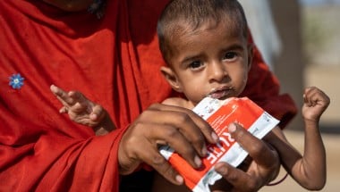 Rashida holds her severely malnourished son, Rasheed (15 months), while feeding him RUTF in Ahmed Jotorr village, Tharparkar. (Photo: Arif Shad/Ingenious Captures/Concern Worldwide)