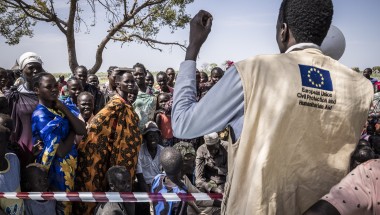 Gatkuoth Matai, Disaster Risk Reduction Officer with Concern South Sudan, speaks to people as they wait for a cash distribution in Chotyiel, Unity State. (Photo: Ed Ram/Concern Worldwide)