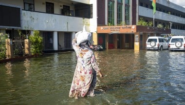 A woman outside the office of Deputy Commissioner in Noakhali district, Bangladesh with flood response materials. Photo: Akram Hossain/Concern Worldwide