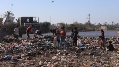 Children in Gaza search through a rubbish dump.
