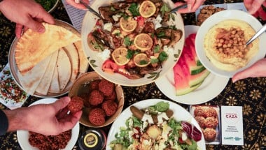  Dinner part scene shown from above. People share Palestinian food. 