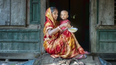 Mitali Mondal is feeding nutritious food to her eighteen months old daughter, Mahi. Every month mothers of the Haldi Bunia community get together once, arrange nutritious meals for their small kids, and feed them together. This session helped mothers to teach each other nutritious meals for their growing children. Several mothers get together and support with the cooking steps. The mother group receives ingredients from the Collective Responsibility, Action, and Accountability for Improved Nutrition (CRAAIN