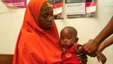 Amburo* (28) holds her youngest child Abshir*. Amburo is a mother of four children from Baidoa, now living in a displacement camp in Daynile District, Mogadishu. Photo: Adnan Mohamed/Concern Worldwide