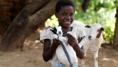 Omega (9) with her goat in Mchiliko, Nsanje. Photo: Jon Hozier-Byrne/Concern Worldwide