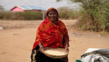 Ralia at her home with her harvested maize which she is currently putting in storage, Tana River, Kenya. Photo: Eugene Ikua/Concern Worldwide.