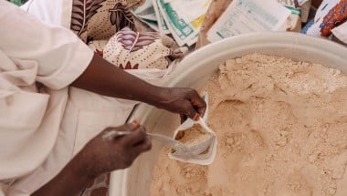 Production of MISOLA® Enriched Flour. Fifteen women from the Afani Yara Women's Group work on the production of Misola. Each 500gr bag sells at 500 cfa. Each child needs 100 gram/day of food supplement for 5 days for recovery. (Photo: Ollivier Girard/Concern Worldwide)