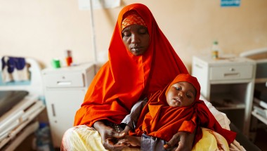 Halima* (40) and her baby Shukri* attend their local health centre. Halima* lives in Igadabagey IDP site in Marka with her five children (3 boys and 2 girls). Halima* was a farmer in Lower Shabelle area but Halima* and her family were displaced after the drought and moved to the IDP site in 2022. Photo: Adnan Mohamed/Concern Worldwide