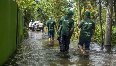 Concern Emergency response team members walk through a submerged road in Noakhali district following the 2024 Bangladesh floods. Photo: Akram Hossain/Concern Worldwide