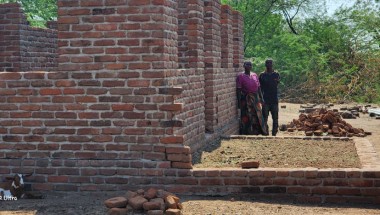 John and his wife Mary standing in front of their resilient house under construction. Photo: Concern Worldwide.