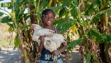 Joyce, 8, holds a chicken that was provided as part of Concern&#039;s RAIN programme to her mother Lillian Shachinda in Zambia. Photo: Gareth Bentley / Concern.