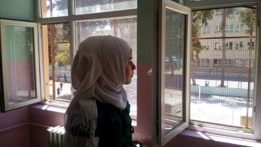 Hasna looks from her classroom window during a break from her studies in a Temporary Education Centre for Syrian refugees in Turkey. Photo: Concern Worldwide.