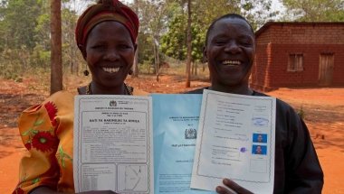 Thomas Vincent Maylinga (53) and Kaleta Sharaba Kabika (47) with their joint land certificate, Kigoma Region, Tanzania. Photo: Jennifer O&#039;Gorman/Concern Worldwide.