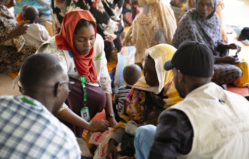Concern Health and Nutrition Officer, Yamen Nassir, with Zarina* and baby Yaqub* at Ardamata Health Centre in West Darfur, Sudan. Yaqub* is severely acutely malnourished and has additional health complications. Photo: Kieran McConville/Concern Worldwide