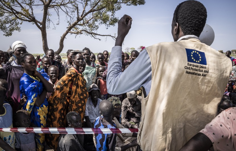 Gatkuoth Matai, Disaster Risk Reduction Officer with Concern South Sudan, speaks to people as they wait for a cash distribution in Chotyiel, Unity State. (Photo: Ed Ram/Concern Worldwide)