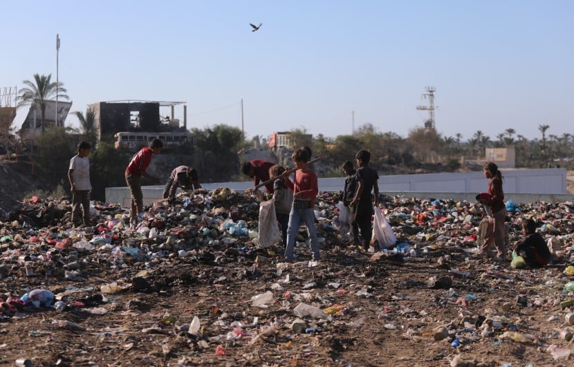 Children in Gaza search through a rubbish dump.