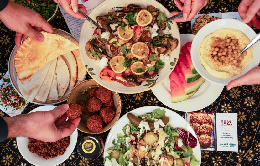  Dinner part scene shown from above. People share Palestinian food. 