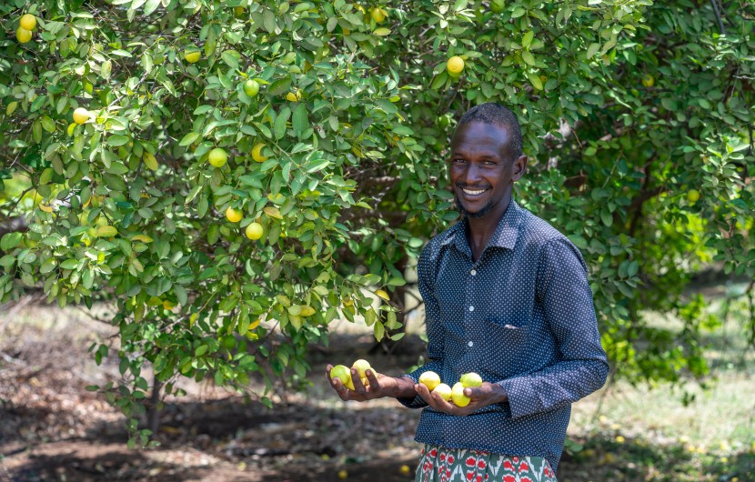Abdi Ade Kiyo poses with some of the limes he has grown