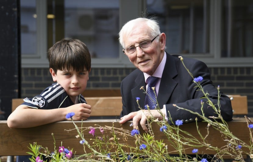 Young boy and Elderly man receive awards for their fundraising efforts 