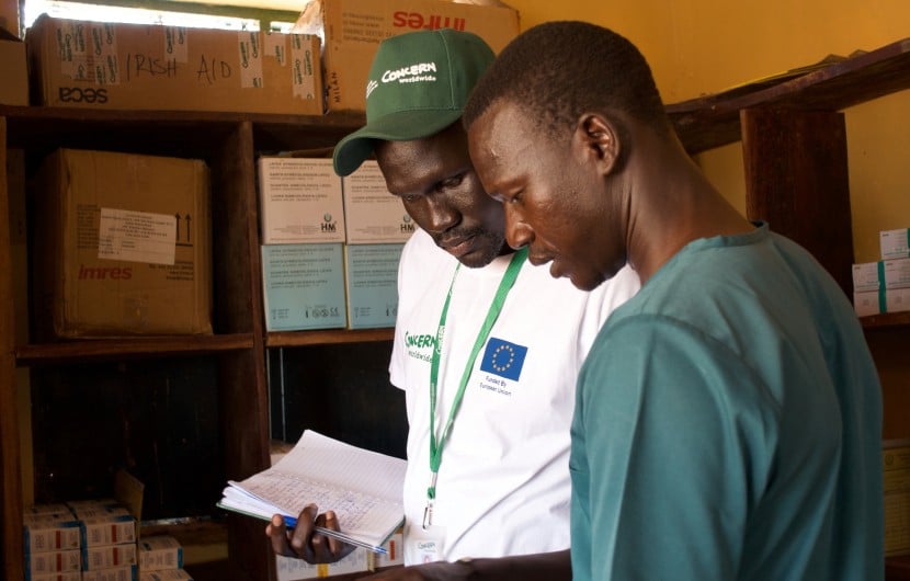 Health and Nutrition Manager Luka Malek Mur and Health Facility Officer checking registers in Northern Bahr al Ghazal, South Sudan. Photo: Hannah Bolder/Concern Worldwide