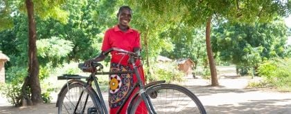 A woman holds a bike