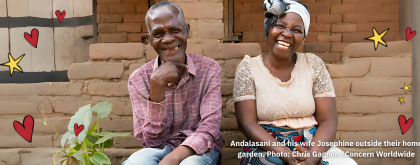 An elderly couple smile