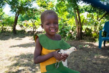 Tamandani 6 with a chicken her family in Malawi was gifted by people like you.