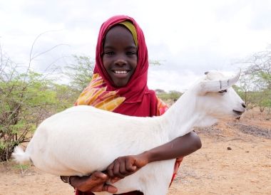 Little Abdia holds Greta, her family’s goat