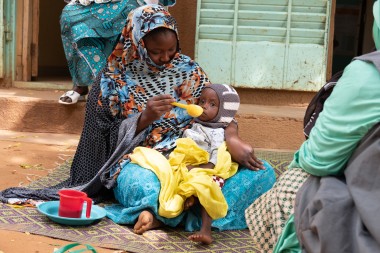 A mother feeds her child