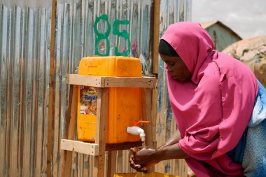 Mothers and children collect water