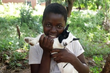 Katherine holds a goat in Malawi