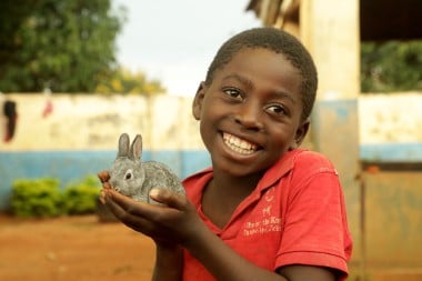 Hope Banda holds a rabbit