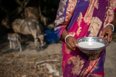 A woman holding a bowl of milk